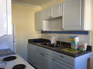 Sea glass tiling decorates the fully-equipped kitchen