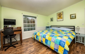 Master bedroom boasts luxurious king size bed with freshly laundered sheets.