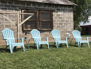 Enjoy a glass of wine on the adirondacks on the front gathering green