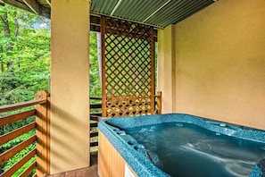 The lower deck boasts a covered deck with a four-person hot tub.