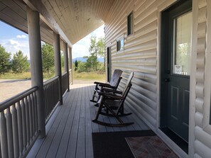 Patio with seating to enjoy the beautiful landscapes of the cabin.