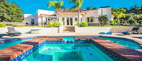 Gorgeous terra cotta style tiling surrounding pool.