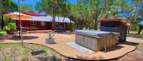 The backyard has an expanded entertaining space with Hot tub.