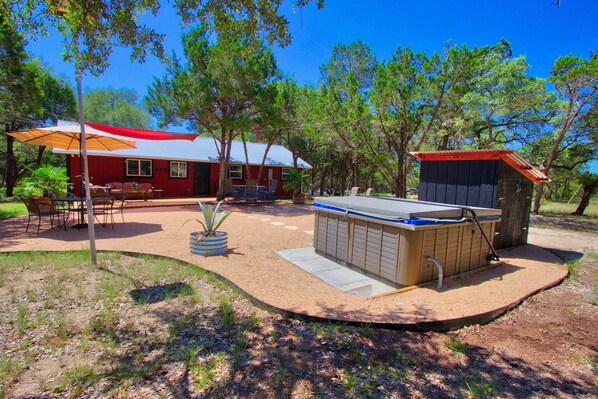 The backyard has an expanded entertaining space with Hot tub.