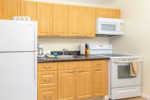 Full kitchen includes refrigerator, stove, oven, and microwave