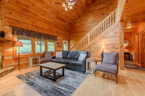 Living Room With Comfy Seating and Rustic Wood Walls