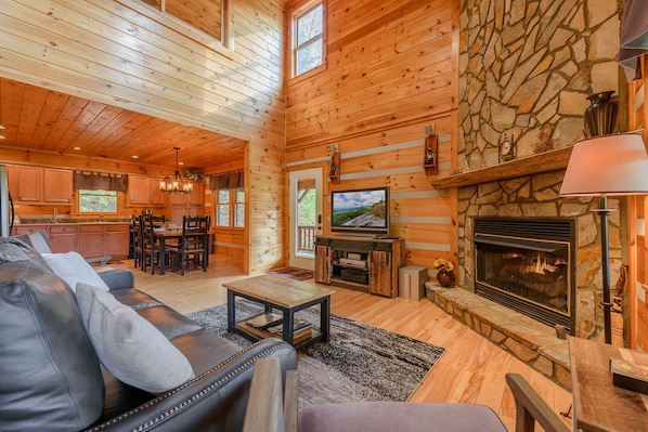 About Time Living Room with Hardwood Floors and Stone Fireplace