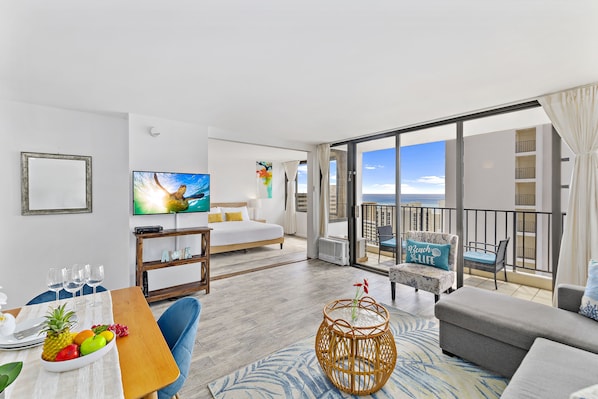 Cozy living room with window AC, cable TV and sliding door that separates the bedroom to the living room