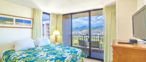 Bedroom with beautiful mountain and city views, king-size bed, and TV!