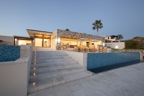 Main entrance. Lap pool to the left with the main pool and jacuzzi on the right.