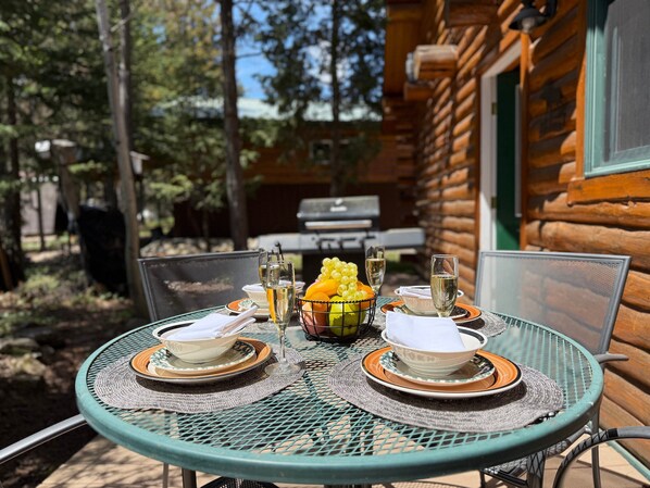 Open deck with a grill and seating.