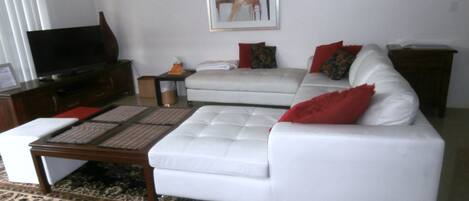 Luxury white leather lounge with colour TV & DVD player