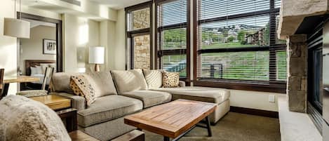 Relax and enjoy the amazing views from this light filled living room with floor to ceiling windows.