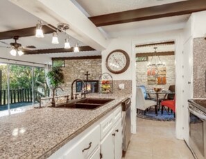 Walk through kitchen to dining area