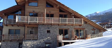 Left hand ground floor apartment and balcony on the snow 