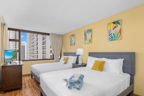 Bedroom with 1 queen-size and 1 full-size bed and a flat-screen TV.