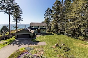 The front yard has so much to offer with a spectacular evergreen forest, and a large lawn to enjoy tossing a Frisbee, playing football or kicking the soccer ball into the goal.