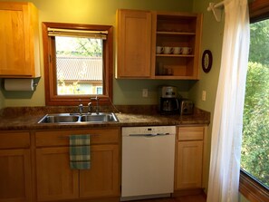 The Kitchen has lots of Light with big windows looking into the front Garden. 