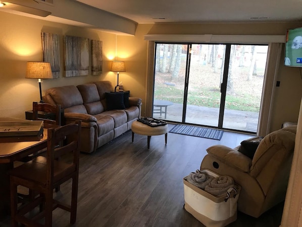 Living room, walk out patio; blinds that close.