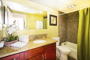Full bathroom with tub and shower combo and a vanity with cabinet.