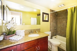 Full bathroom with tub and shower combo and a vanity with cabinet.