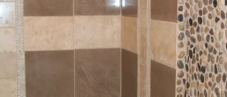 Stunning shower tile and mosaic rock compliment modern and rustic