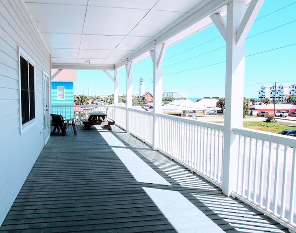 Deep wrap-around veranda with picnic table and sitting area to enjoy Gulf views.