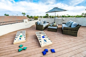 The rooftop lounge comes with cornhole-–always a crowdpleaser.