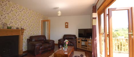 beautiful sitting room leading to large decked area and garden.
