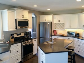 Well equipped kitchen, gas range, 2 sinks & walk out to balcony