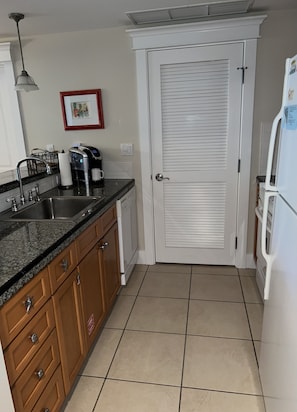 Fully equipped kitchen-stove, microwave, dishwasher--washer/dryer behind door  
