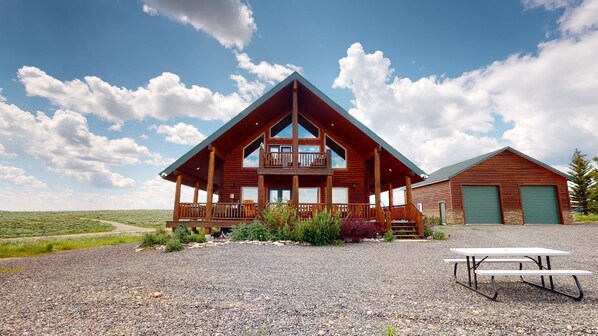Beautiful log cabin exterior that exudes a rustic, cozy charm that blends seamlessly with the natural beauty of the surrounding landscape.