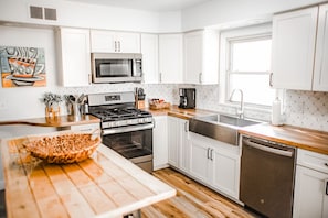 The kitchen with pleny of pots and pans to cook a great meal 
