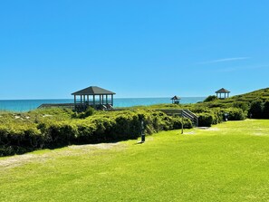Large recreational area with outdoor showers, picnic tables, charcoal grills.