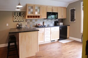 Kitchen has cooktop, microwave, mini-fridge, coffee maker.