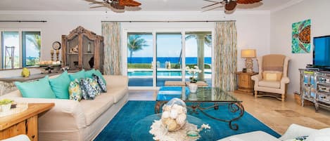 Bright and colorful living room with turquoise sea views.