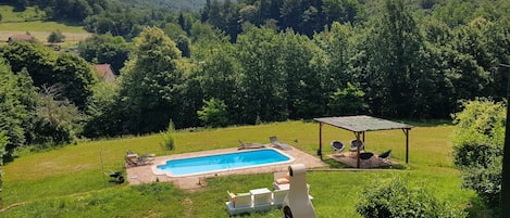 Overlooking the garden, pool, BBQ and surrounding private land. 