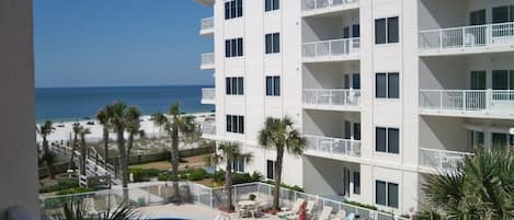 A view from the balcony to the Pool and Beach