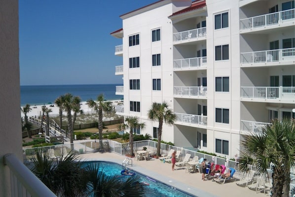 A view from the balcony to the Pool and Beach