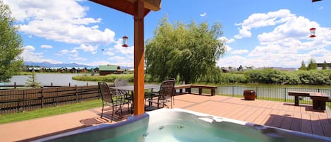 hot tub on the deck over looking the lake and beautiful mountain views