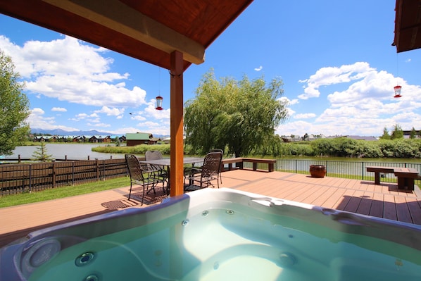 hot tub on the deck over looking the lake and beautiful mountain views