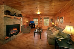 Lovely Living Room - Now featuring new sleeper sofa. Enjoy TV with your family or friends during your vacation on every level of your cabin. This cabin is just 2 miles to the Pigeon Forge strip!