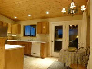 Kitchen. All pine ceilings with LED Lighting.  Our PV array covers 100% Electric.