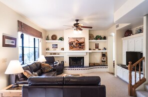 leather sofa and loveseat overlooks gas fireplace and huge view window