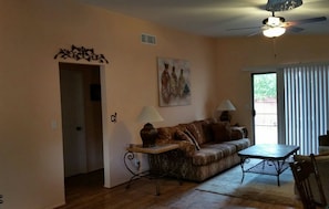 Spacious living room. Hallway leading to bedrooms and bathroom.
