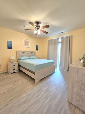Master bedroom, newly renovated floors, sliding door to the balcony w pond view.