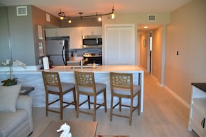 Plenty of surface area and seating for 3 to eat, more seating at dining table