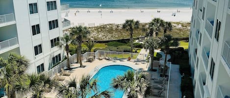 View of pool courtyard and Gulf of Mexico from the unit balcony.