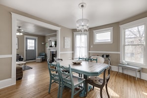 Dining room adjacent to living room with desk area and extra seating