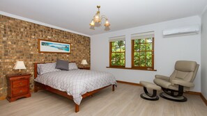 Spacious main bedroom with robes, separate sitting area and nice tree top view.